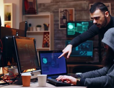 Dangerous hooded hacker and her partner hacking the government planting a malware.