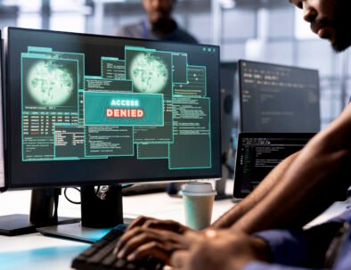 Computer scientist in server farm fighting hacker managing to pass firewall and stealing data. Employee receiving access denied notification on PC display in data center facility